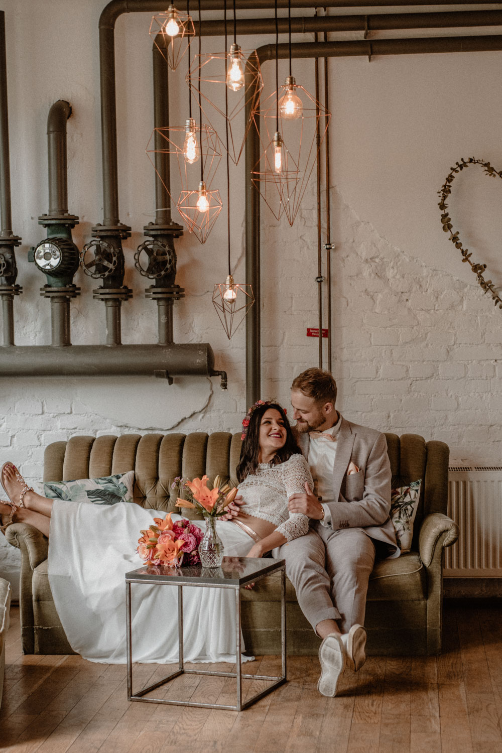Brautpaar sitzt auf Couch im Industrial-Stil