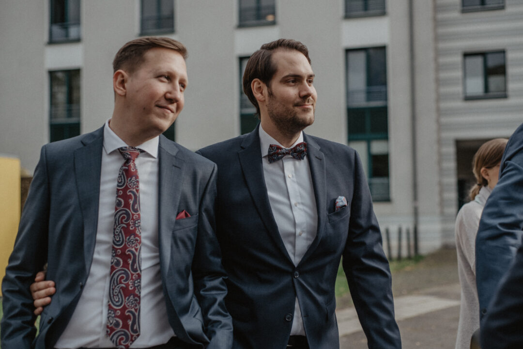 Bräutigame Arm in Arm auf dem Weg zur Hochzeit