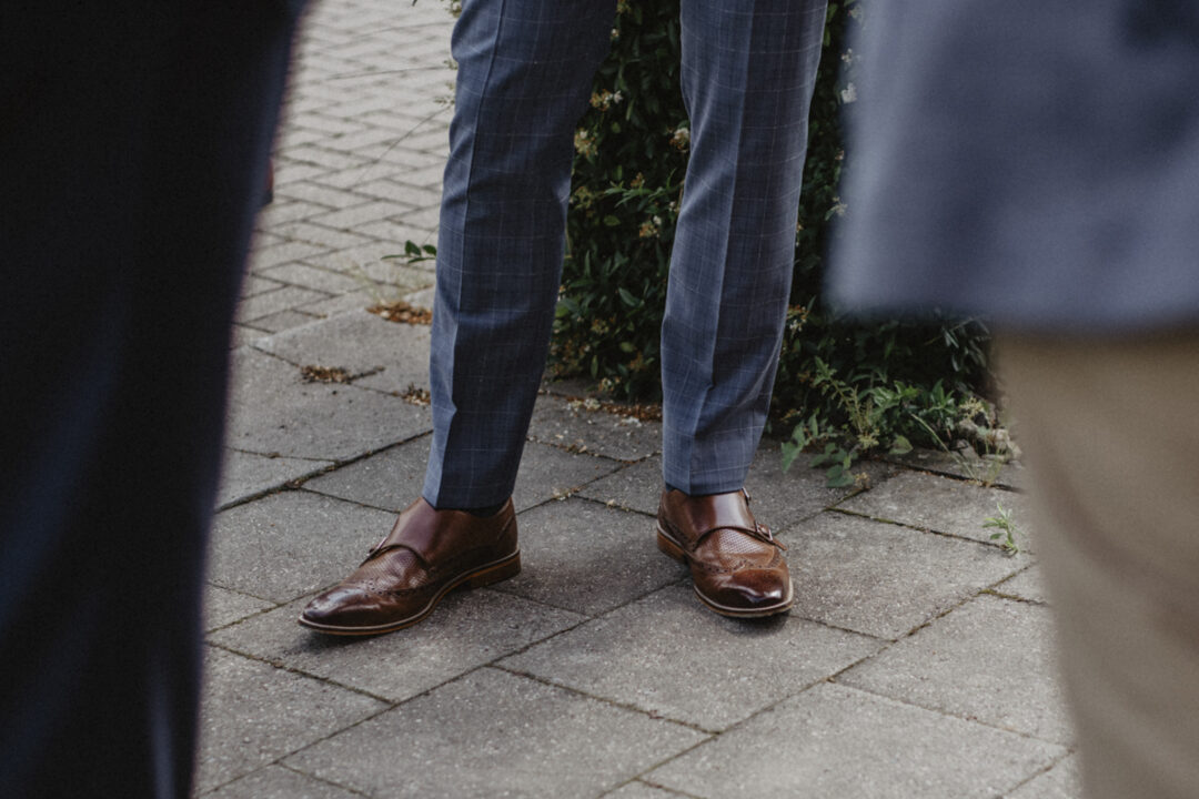 Detailaufnahme eleganter Hochzeitsschuhe und Anzughosen