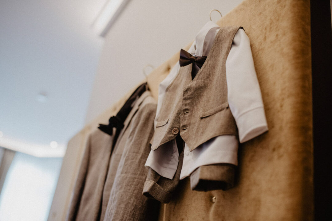 Kinderanzug mit Fliege hängt im Hotelzimmer