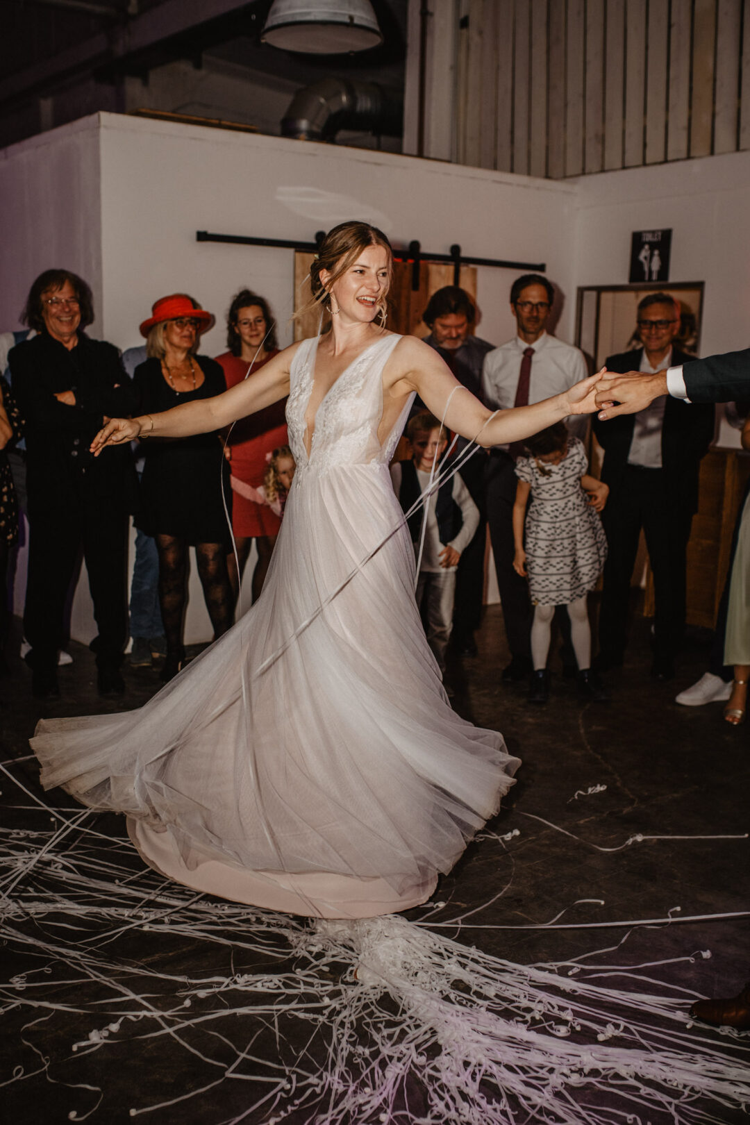 Braut dreht sich beim Tanz unter Applaus der Gäste