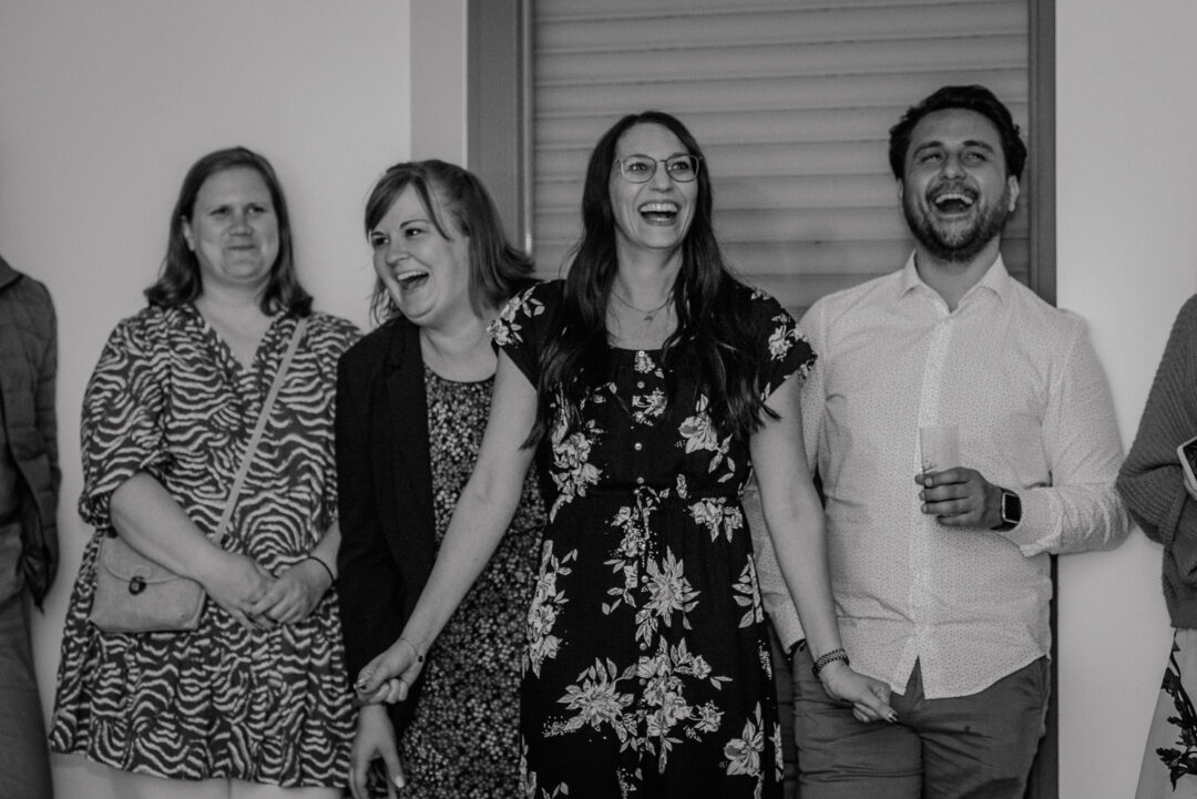 Gäste lachen bei Hochzeitsspiel