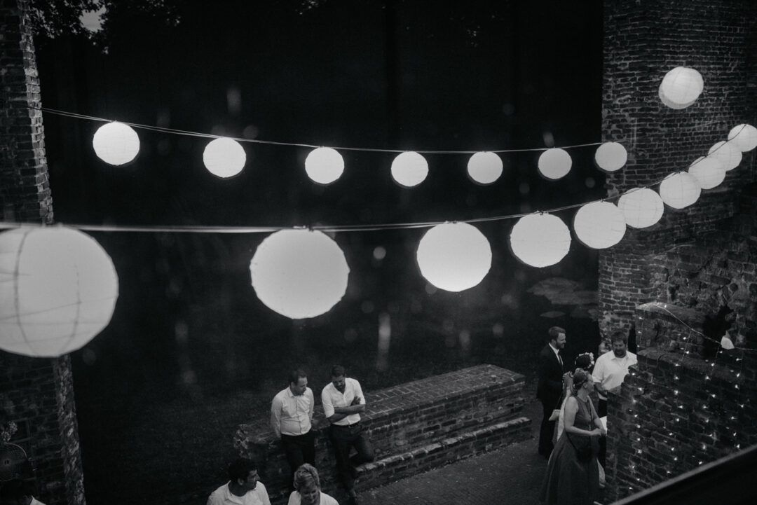 Hochzeitsgäste unter beleuchteten Lampions