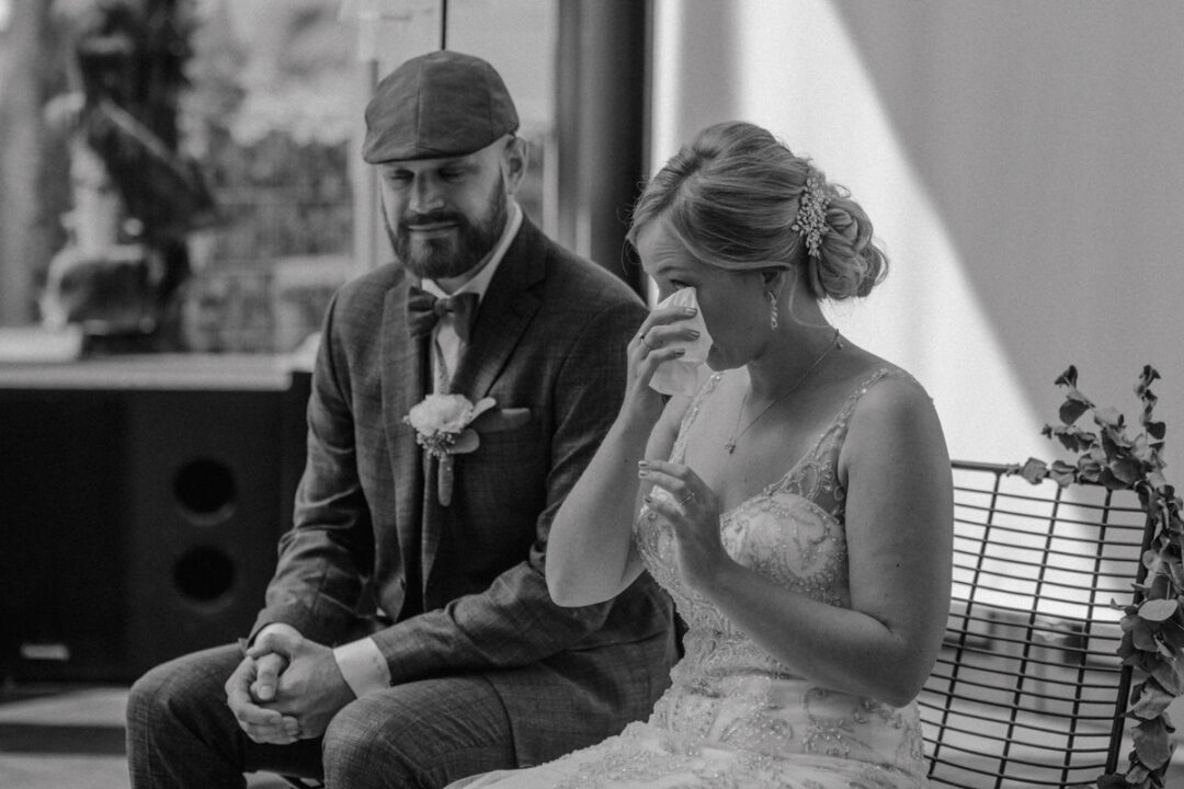 Braut wischt sich während der Trauung die Tränen aus den Augen