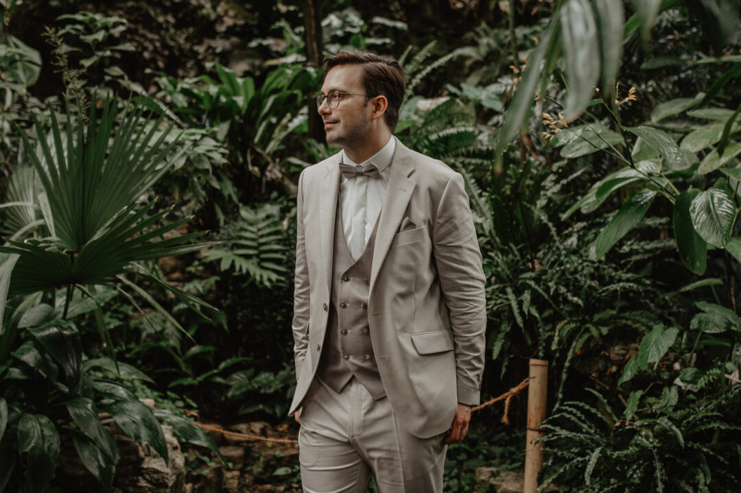 Bräutigam steht lächelnd im Tropenhaus Osnabrück