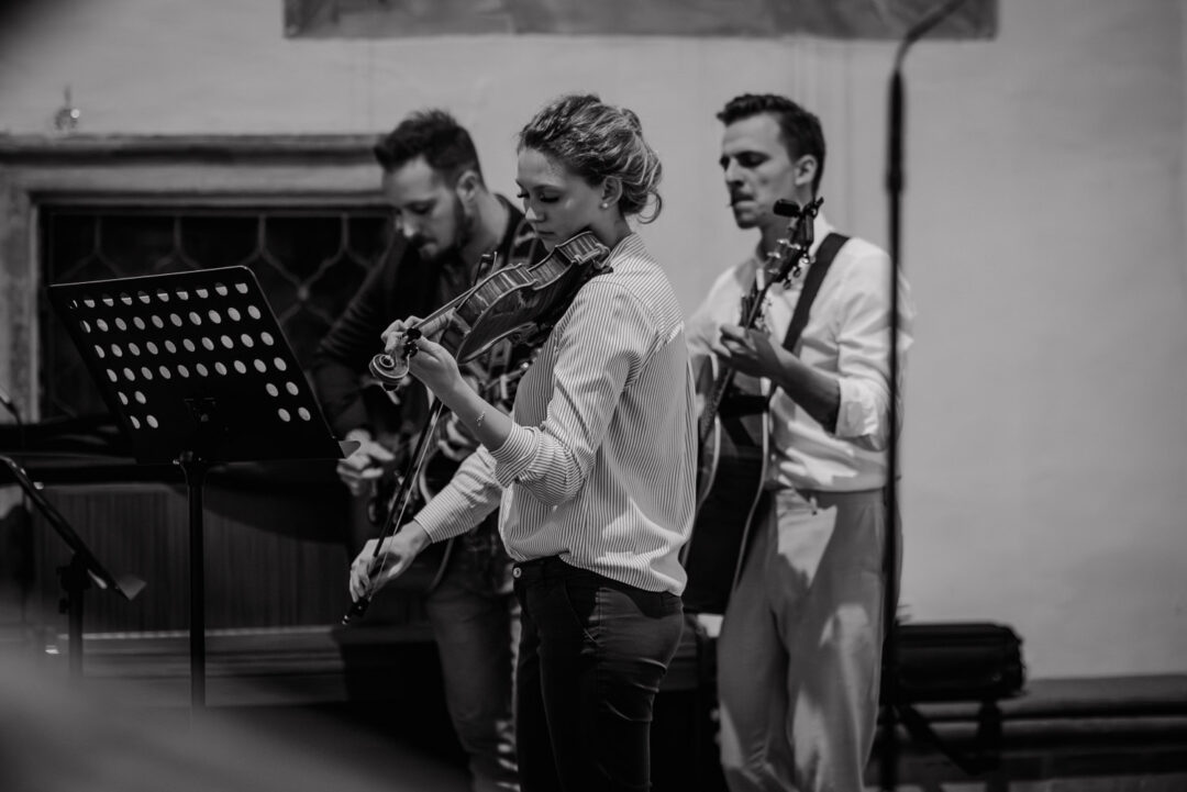 Musiker spielen Geige und Gitarre live während der kirchlichen Trauung, SW.